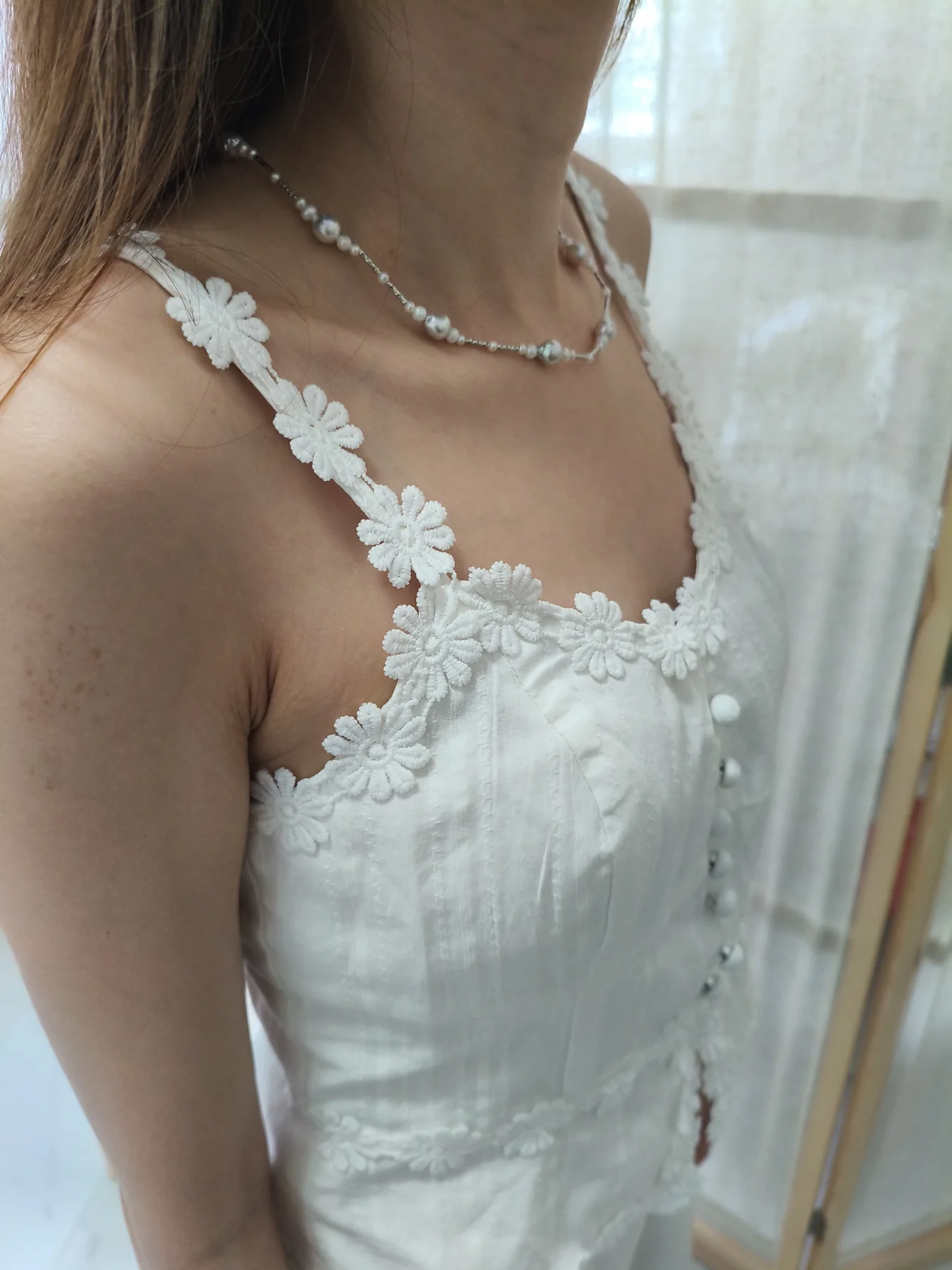Close-up of lace and floral applique on a bridal dress