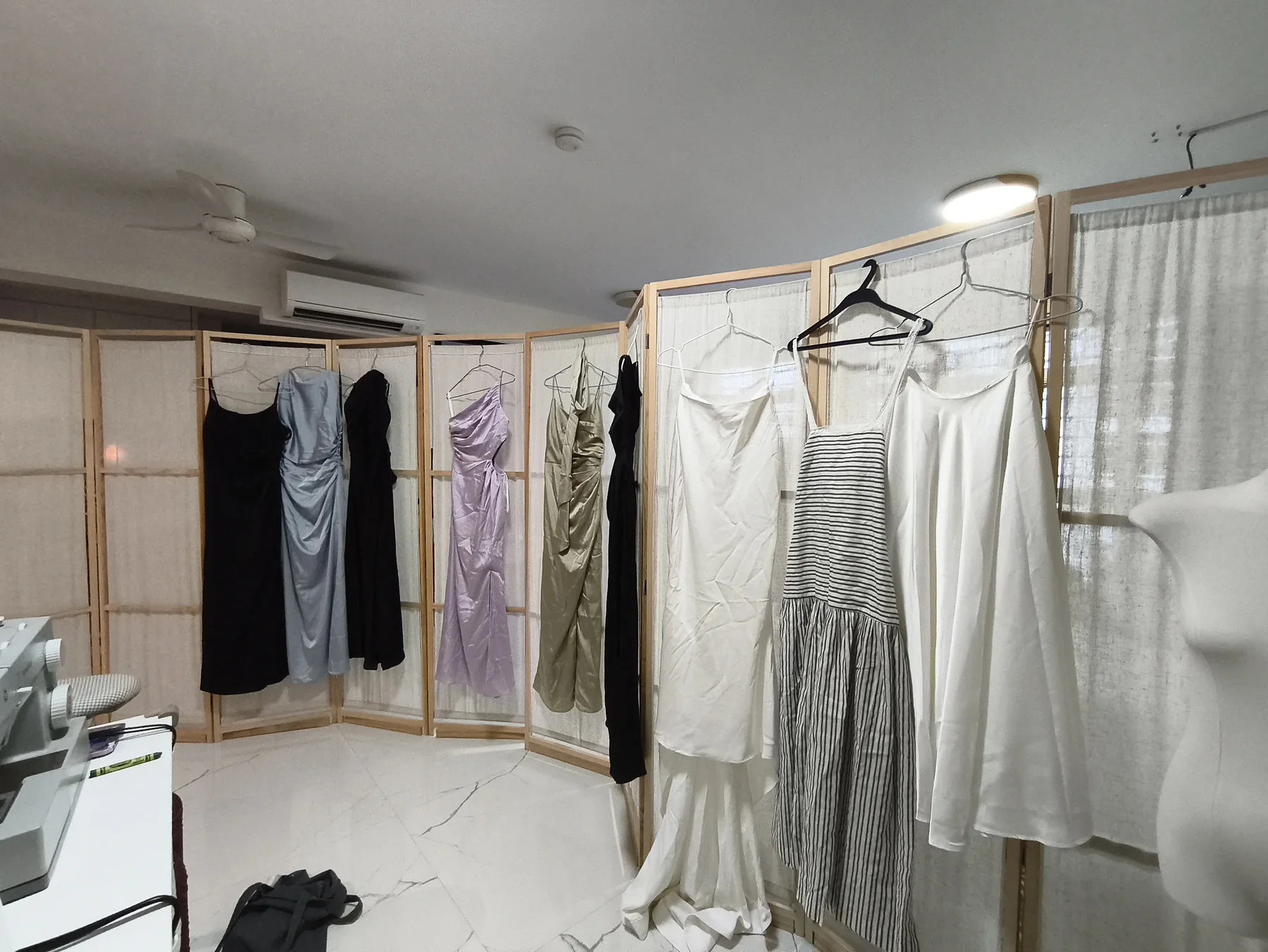 Finished garments hanging in the studio ready for customer collection