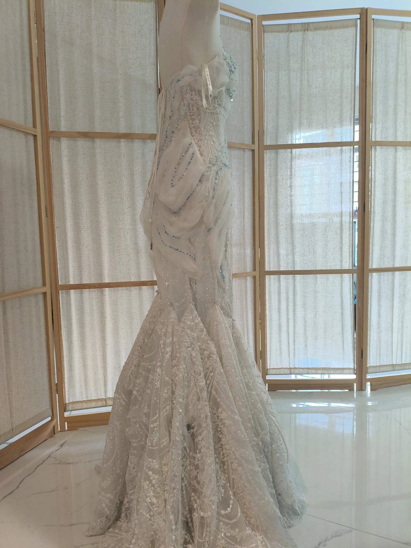 Finished embellished wedding dress displayed in the fitting studio