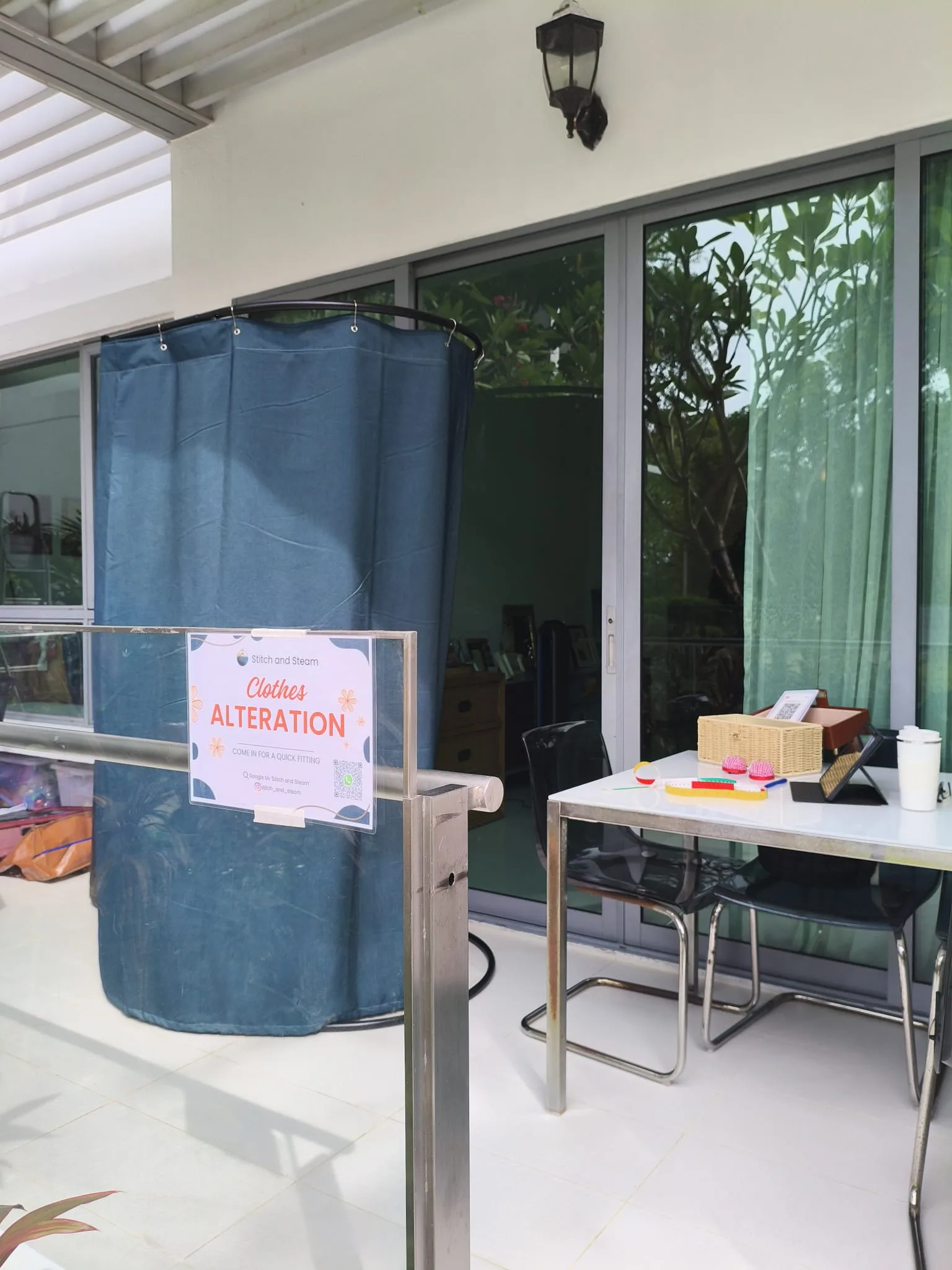 Stitch and Steam pop-up alteration setup at a condominium common area