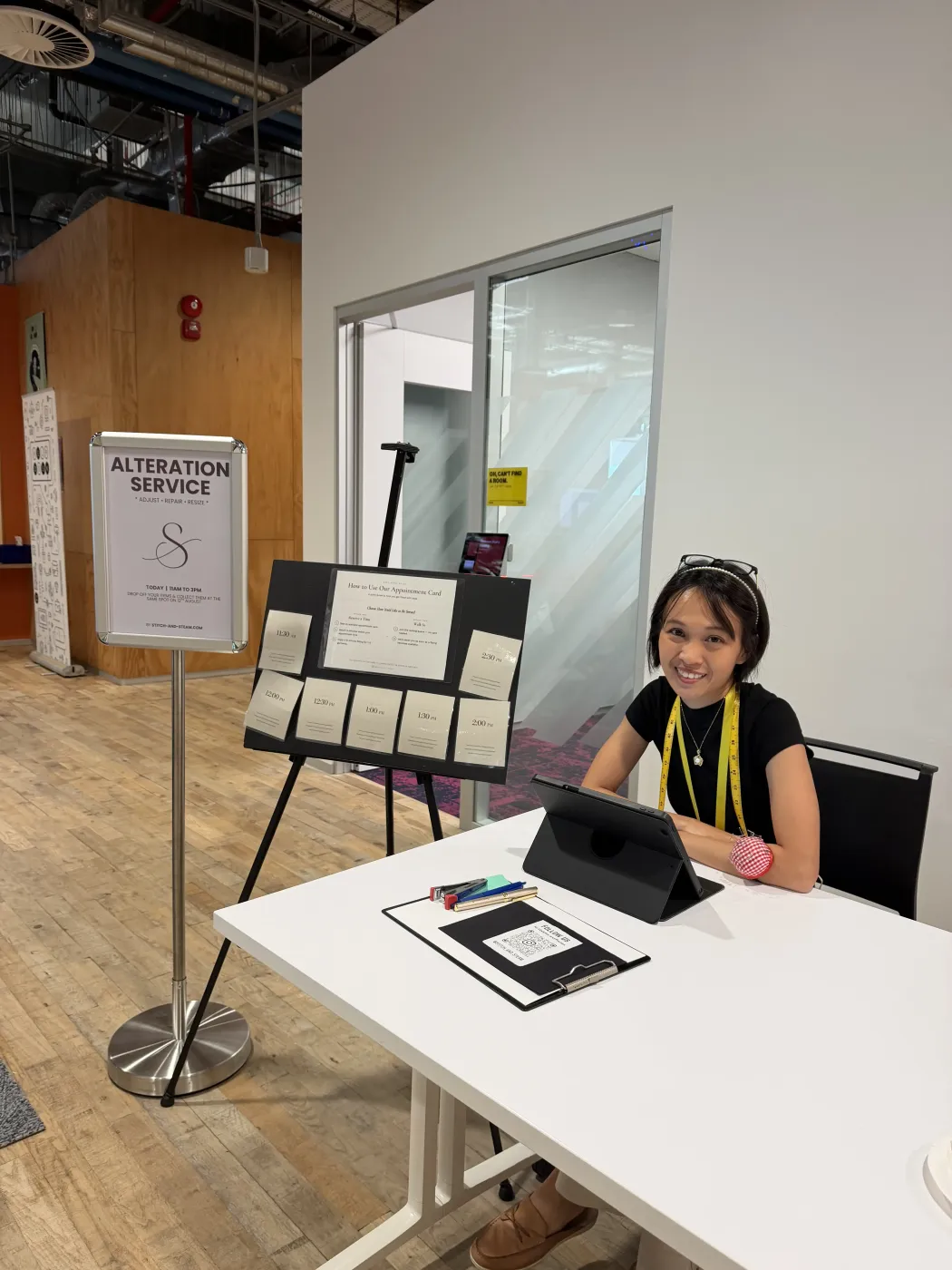 Appointment scheduling board and staff desk at a Stitch and Steam office pop-up