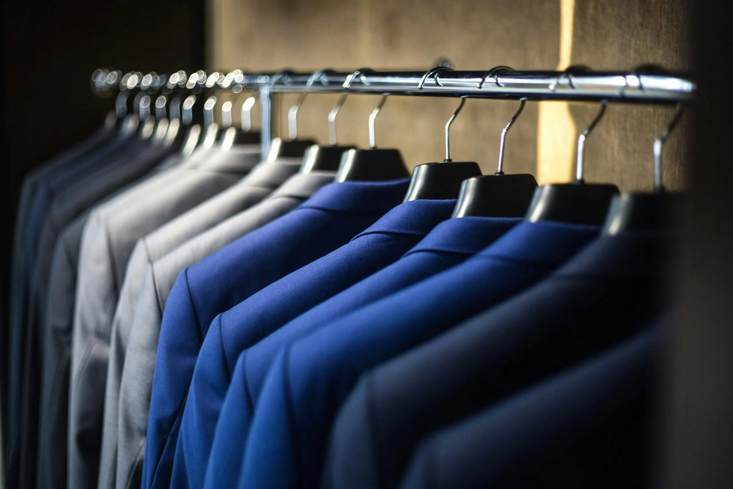 rack of jackets for alterations by professional stitch & steam tailor